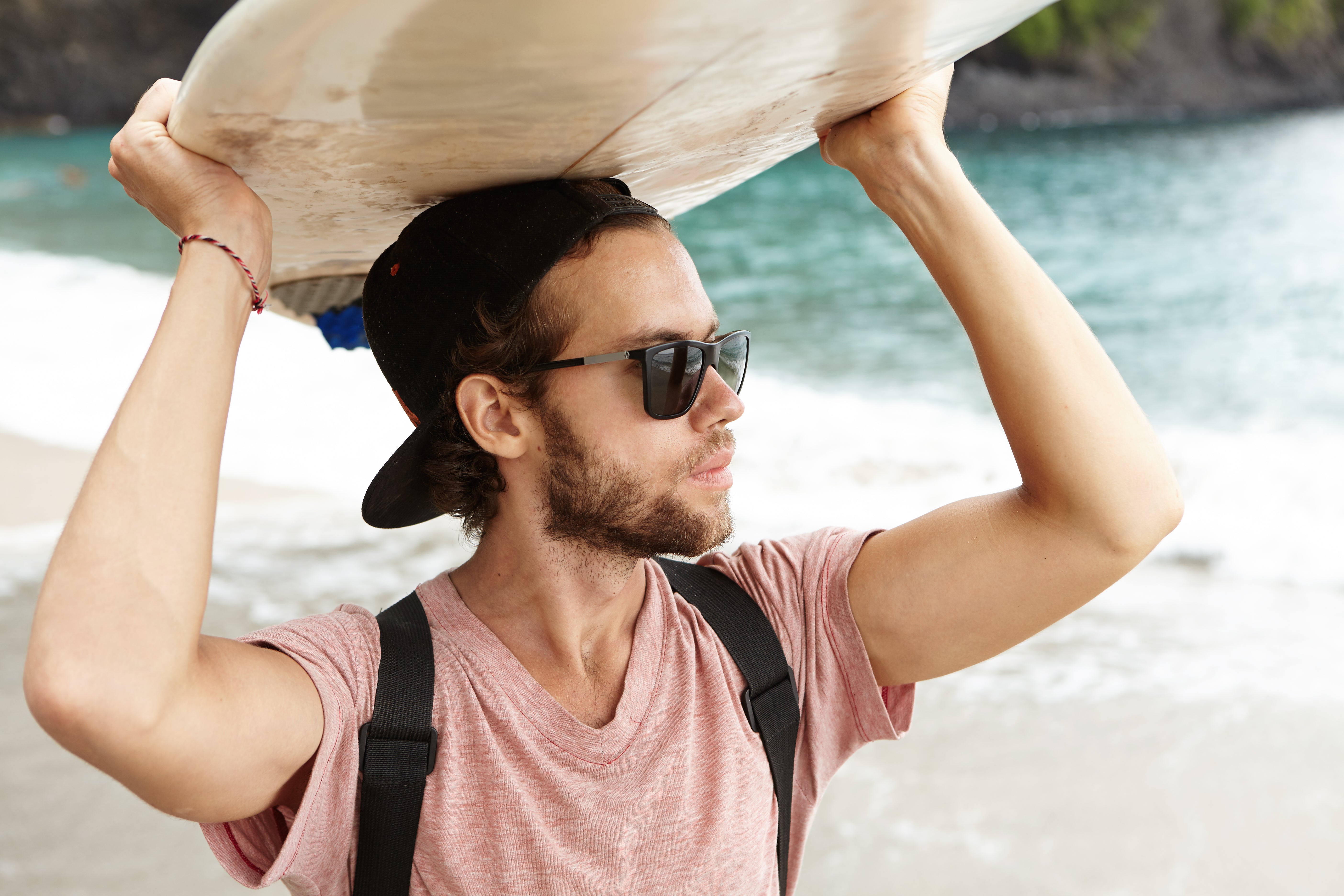 files/attractive-young-bearded-man-wearing-shades-carrying-bodyboard-his-head-looking-ocean.jpg
